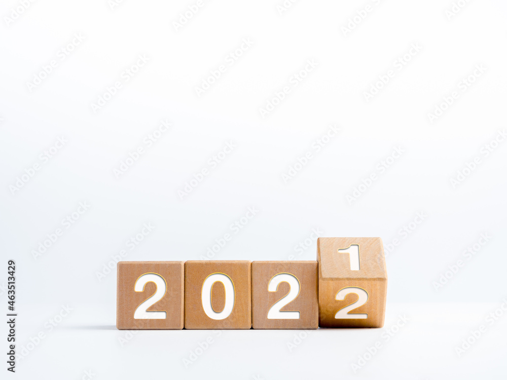 Poster turning year numbers for change from the calendar year 2021 changed to 2022 on wooden cube blocks is