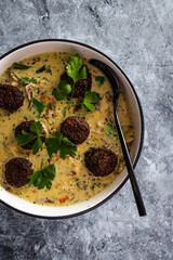 vegan green curry with mixed vegetables and plant-based meatballs, healthy plant-based food