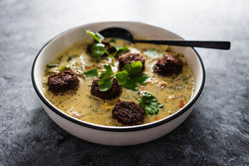 vegan green curry with mixed vegetables and plant-based meatballs, healthy plant-based food