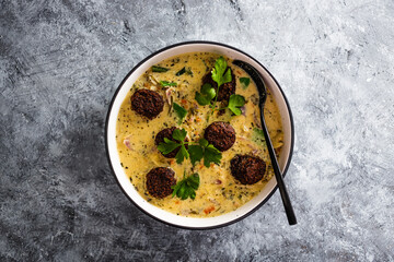 vegan green curry with mixed vegetables and plant-based meatballs, healthy plant-based food