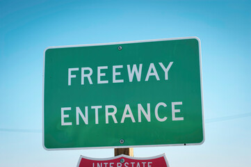 freeway entrance sign with blue sky