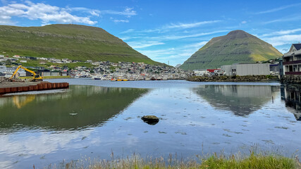 Beautiful aerial view of the City of Klaksvik in the Fareo Islands with its colorful houses and amazing canal and view to the majestic Kunoy Park