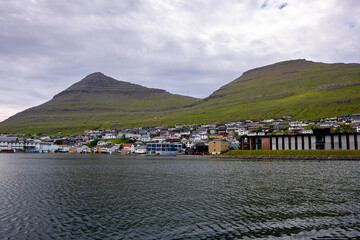 Beautiful aerial view of the City of Klaksvik in the Fareo Islands with its colorful houses and amazing canal and view to the majestic Kunoy Park