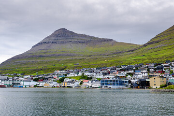 Beautiful aerial view of the City of Klaksvik in the Fareo Islands with its colorful houses and amazing canal and view to the majestic Kunoy Park