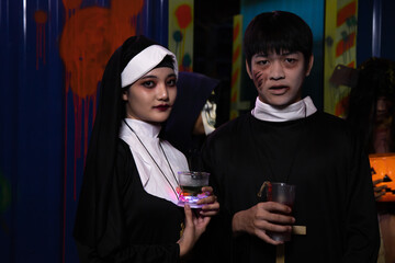 Young people in nun and priest costume.