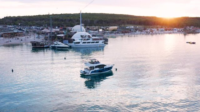 Scenic Sunset Over Zrce Festival Beach, Popular Beach With Party Boat And Yacht In Novalja, Croatia. - aerial pullback