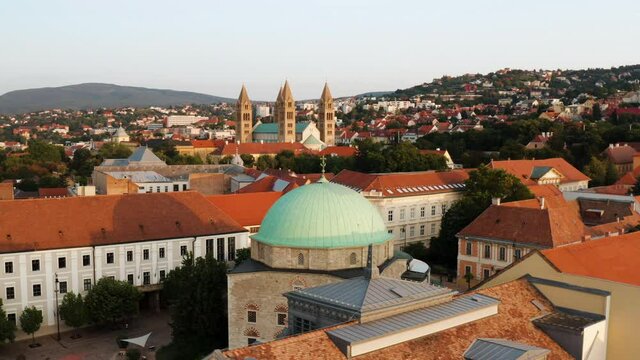 Mosque Of Pasha Qasim In Pecs, Hungary With Pecs Cathedral In Distance. aerial orbit