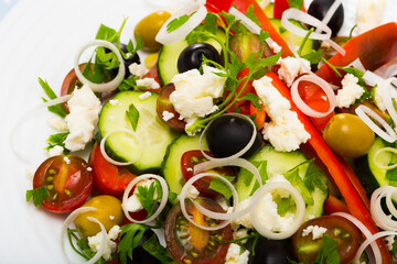 Traditional sopska salad with fresh tomato, onion, cucumber and brynza cheese