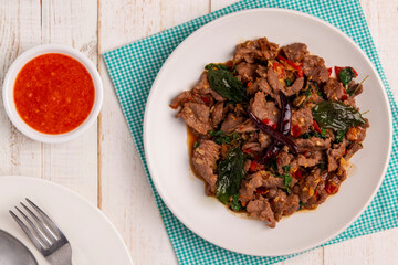 Flat lay Stir-fried holy basil beef slices, pad kaprao neua, a hot and savory Thai dish that can be...