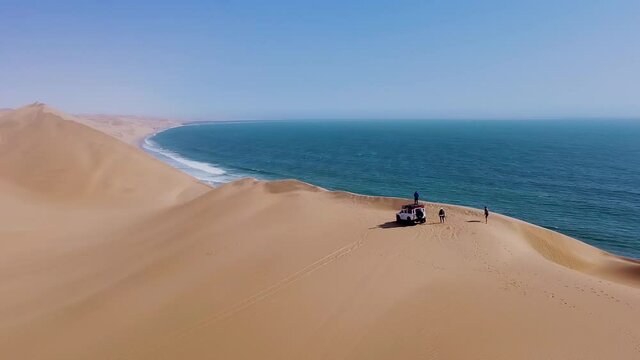 Aerial view of travelers exploring the scenic Namib desert dunes, Africa