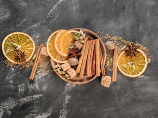A set of spices for mulled wine. Cinnamon sticks, anise stars, nutmeg, brown sugar. Copy space.