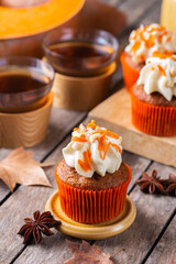 Homemade autumn pumpkin cupcakes or muffins with nuts and spices