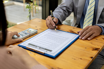 Two people are doing corrupt behavior, they are mutual business partners and are signing contracts to receive bribes for mutual benefit. The concept of business fraud and bribery is illegal.