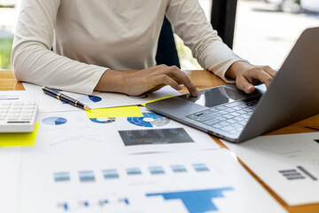 Close-up A business woman working in a private room, She is typing on a laptop keyboard, She uses a messenger to chat with a partner. Concept of using technology in communication.