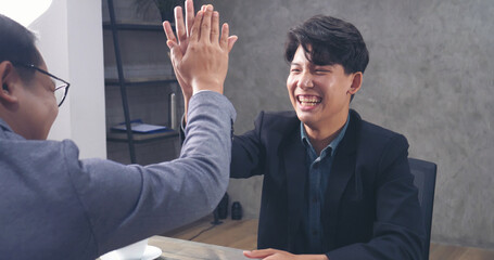 Two businessmen talking together at office desk, business meeting room with happiness and make high...