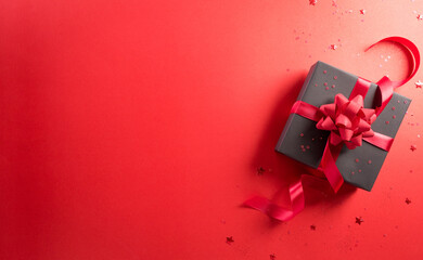 Online shopping of China, 11.11 singles day sale concept. Top view of black christmas gift boxes with star on red background with copy space.