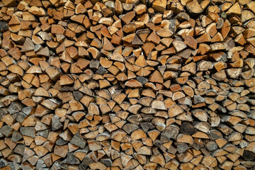 Detail of wood pile. use brown structure as background. freshly chopped firewood. 