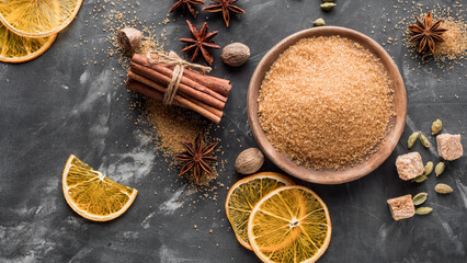 A set of spices for mulled wine. Cinnamon sticks, anise stars, nutmeg, brown sugar. Copy space.