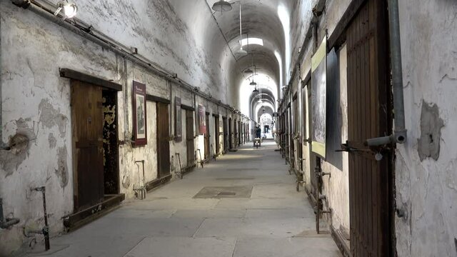 Prison cell block at Eastern State Penitentiary from right side of aisle.