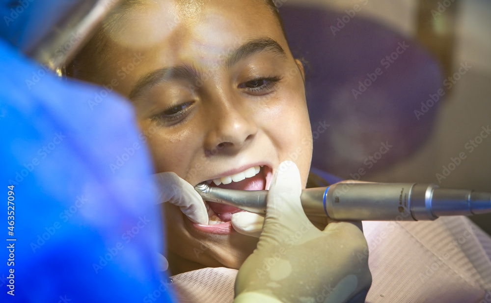 Canvas Prints Young caucasian female with dentist in white latex gloves check condition of her teeth. baby girl in blue dental chair.