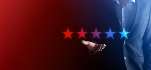 Man hand showing on five star excellent rating.pointing five star symbol to increase rating of company.Review, increase rating or ranking, evaluation and classification concept