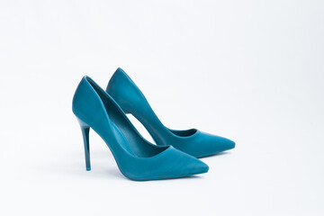 A pair of blue high-heeled shoes. Suede women's elegant shoes on a white background. Beautiful high and feminine heel