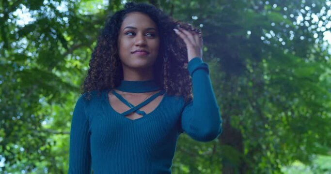 Pretty young model walks before turning and playing in her hair