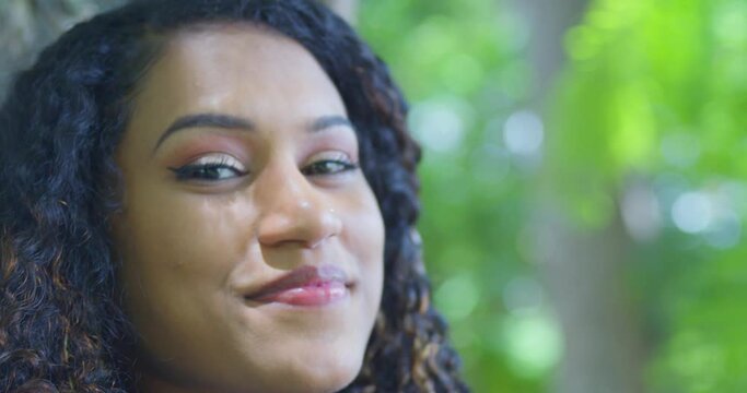 Facial close up of an east indian model with curly hair and a nose ring