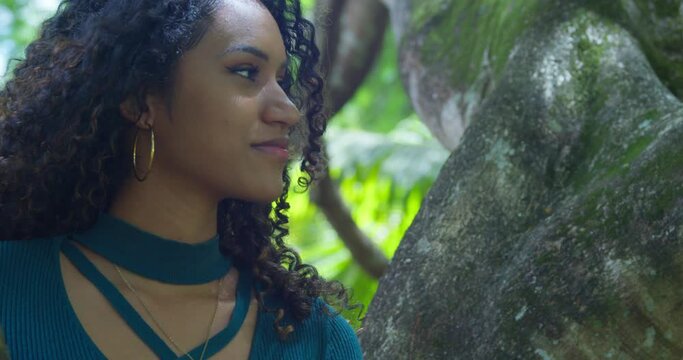 Close up facial of a curly hair young girl on a tropical island with blowing her hair
