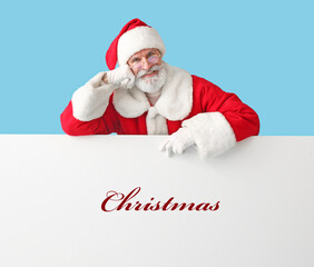Santa Claus and poster with word CHRISTMAS on blue background
