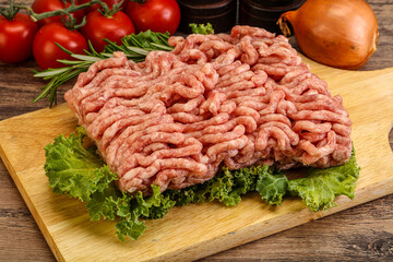 Raw pork minced meat over board