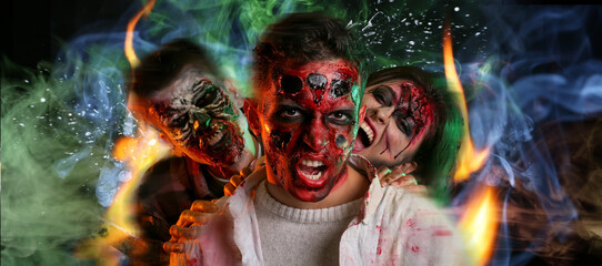 Scary zombies on dark background with burning flame and smoke