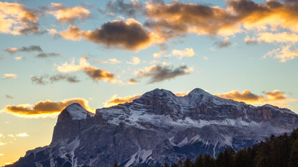 Fototapeta na wymiar Sunset over Tofana mountain group with the highest peak Tofana di Rozes. Dolomites Alp Mountains, Belluno Province, Dolomiti Alps, Italy