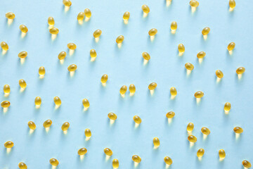 Vitamin A capsules on blue background