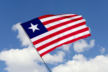 Liberia flag isolated on the blue sky background. close up waving flag of Liberia. flag symbols of Liberia. Concept of Liberia.