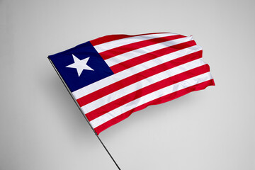 Liberia flag isolated on white background. close up waving flag of Liberia. flag symbols of...