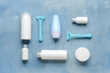 Composition with safety razors and cosmetic products on color background