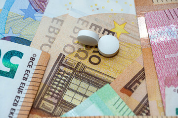 Medical tablets on euro banknote as background