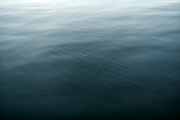The surface of the water with a gradient of color from dark to light