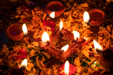 Group of diyas in flower petals during Diwali