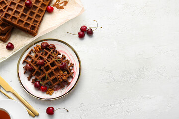Plate of delicious Chocolate Belgian Waffles with cherry and walnut on white background
