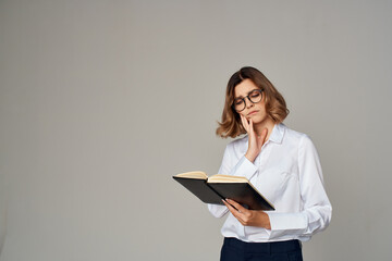 woman in suit with documents in hand work light background