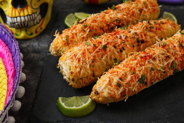 Board with tasty Elote Mexican Street Corn on black background, closeup