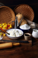 Pumpkin, tomatoes, cottage cheese, starch, salt, soy sauce, sesame and vegetable oil on a wooden table