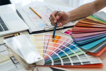 Discussion about colours to a new project. Designer's workplace with hands