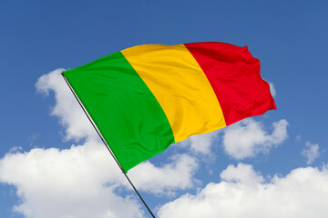 Mali flag isolated on the blue sky background. close up waving flag of Mali. flag symbols of Mali. Concept of Mali.
