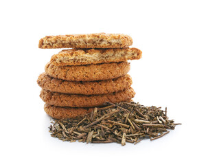 Tasty hojicha cookies and dry leaves on white background