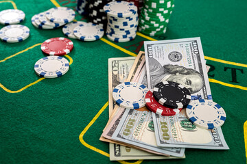 game chips with a column of bucks of dollars laid out after the game