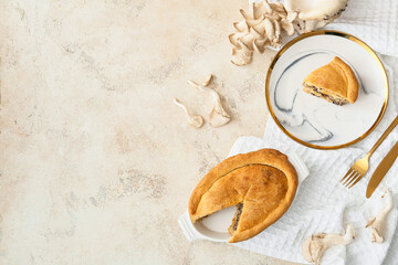 Fototapeta na wymiar Baking dish and plate with tasty mushroom pot pie on light background
