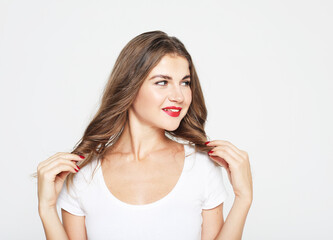 Young cute smiling blond woman wearing white t-shirt